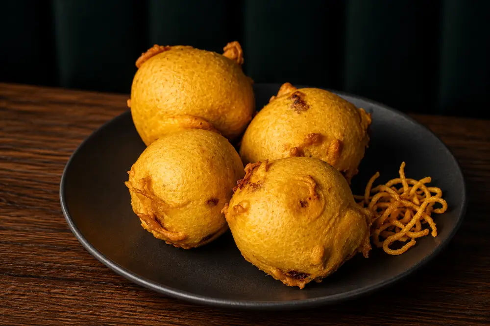 Plate of four golden fried Batata Vadas
