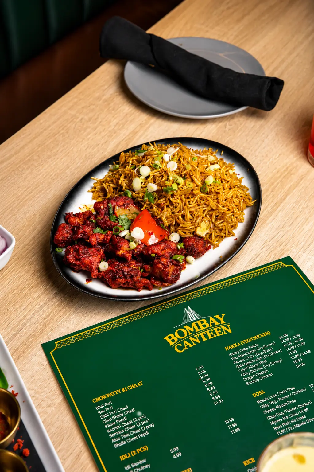Plate of Indo-Chinese Fried Rice served with crispy spicy Chicken Manchurian